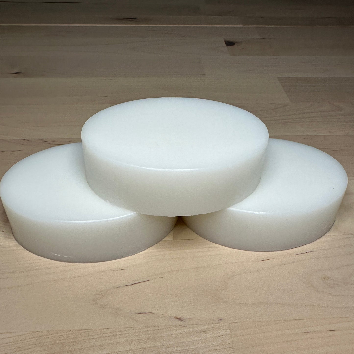 Three white bars of soap stacked as a pyramid