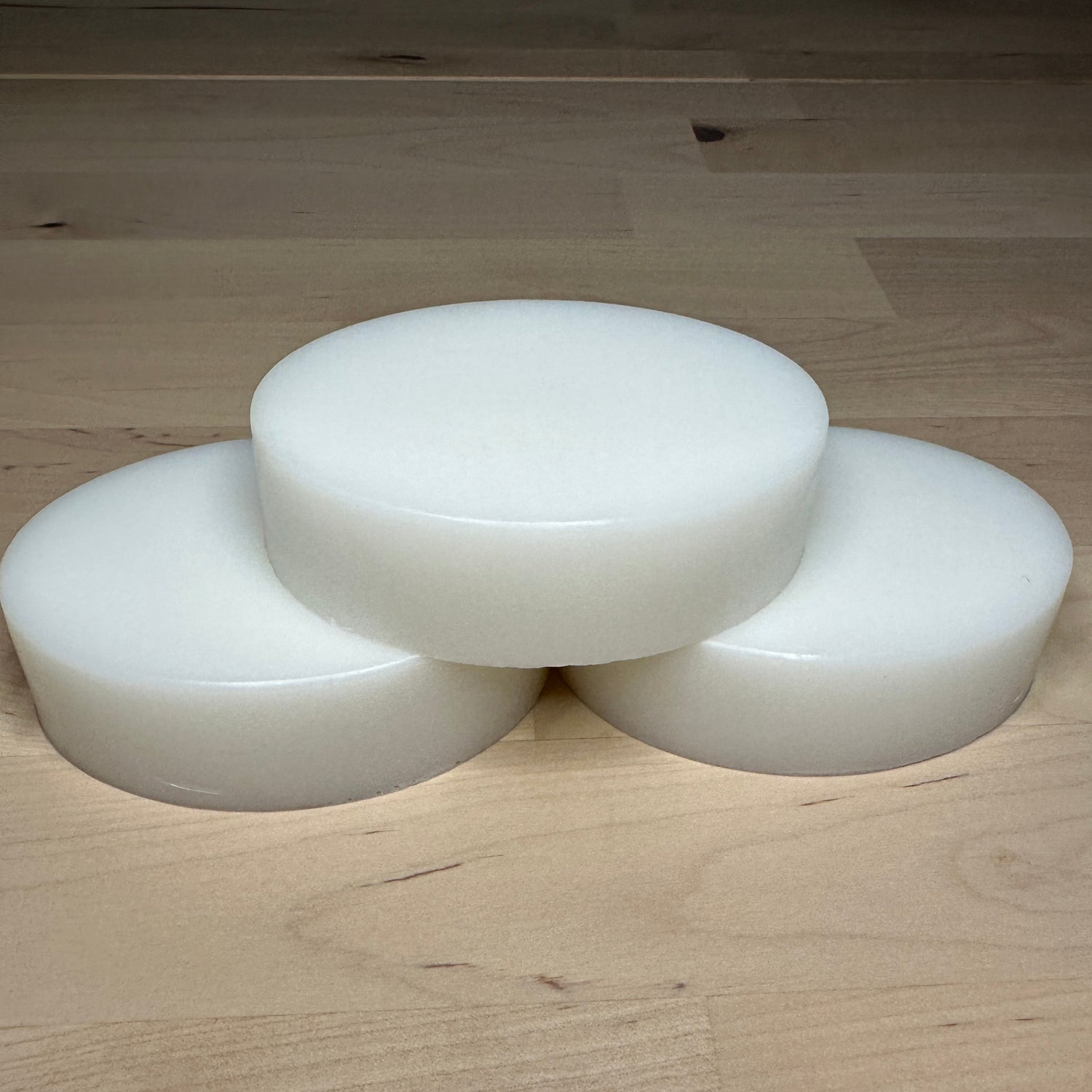Three white bars of soap stacked as a pyramid