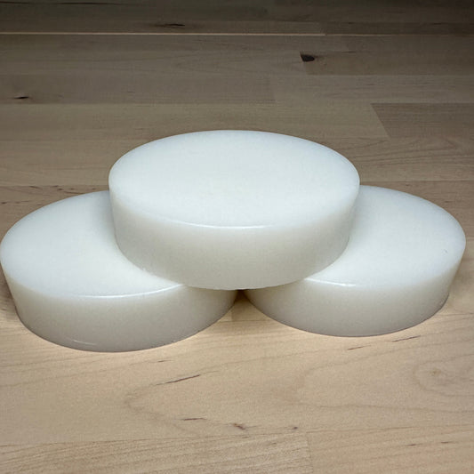 Three white bars of soap stacked as a pyramid